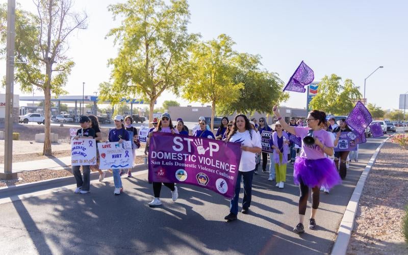 Participants walk through San Luis, AZ during the Walk Against Domestic Violence on October 4, 2024.