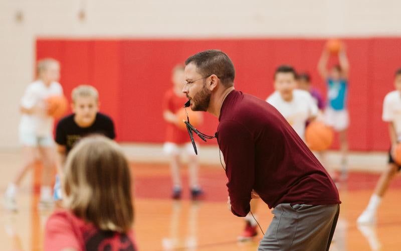 Coach Isaacs leads students through drills at the 2022 Chapman Automotive Winter Basketball Camp.