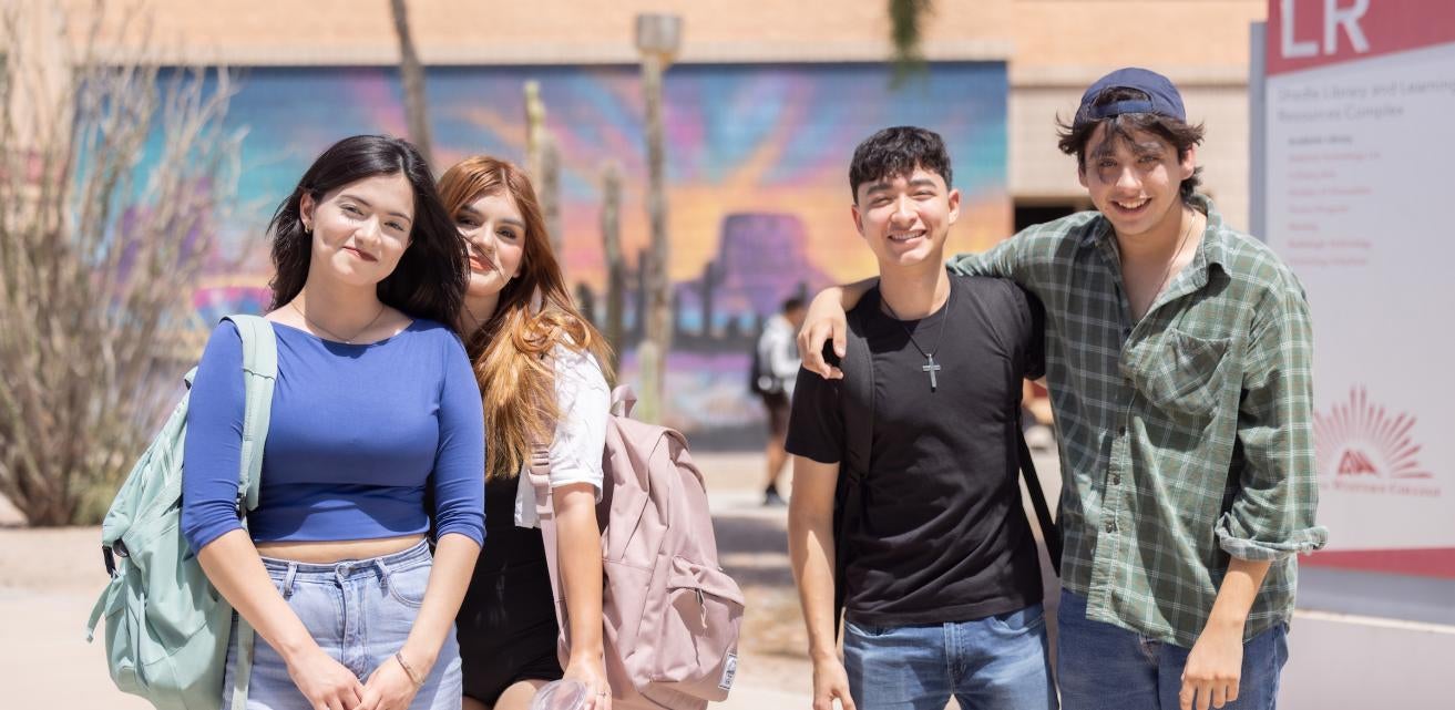 A group of students, male and female, in front of the LR building